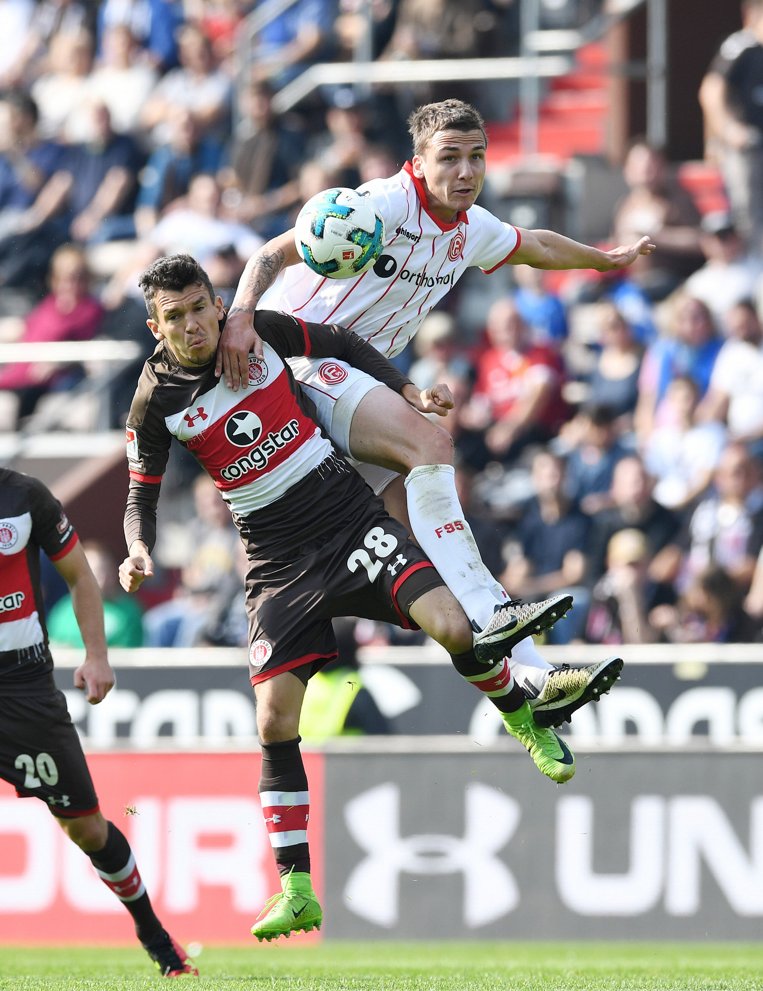 Waldemar Sobota challenges for the ball with Düsseldorf's Marcell Sobottka