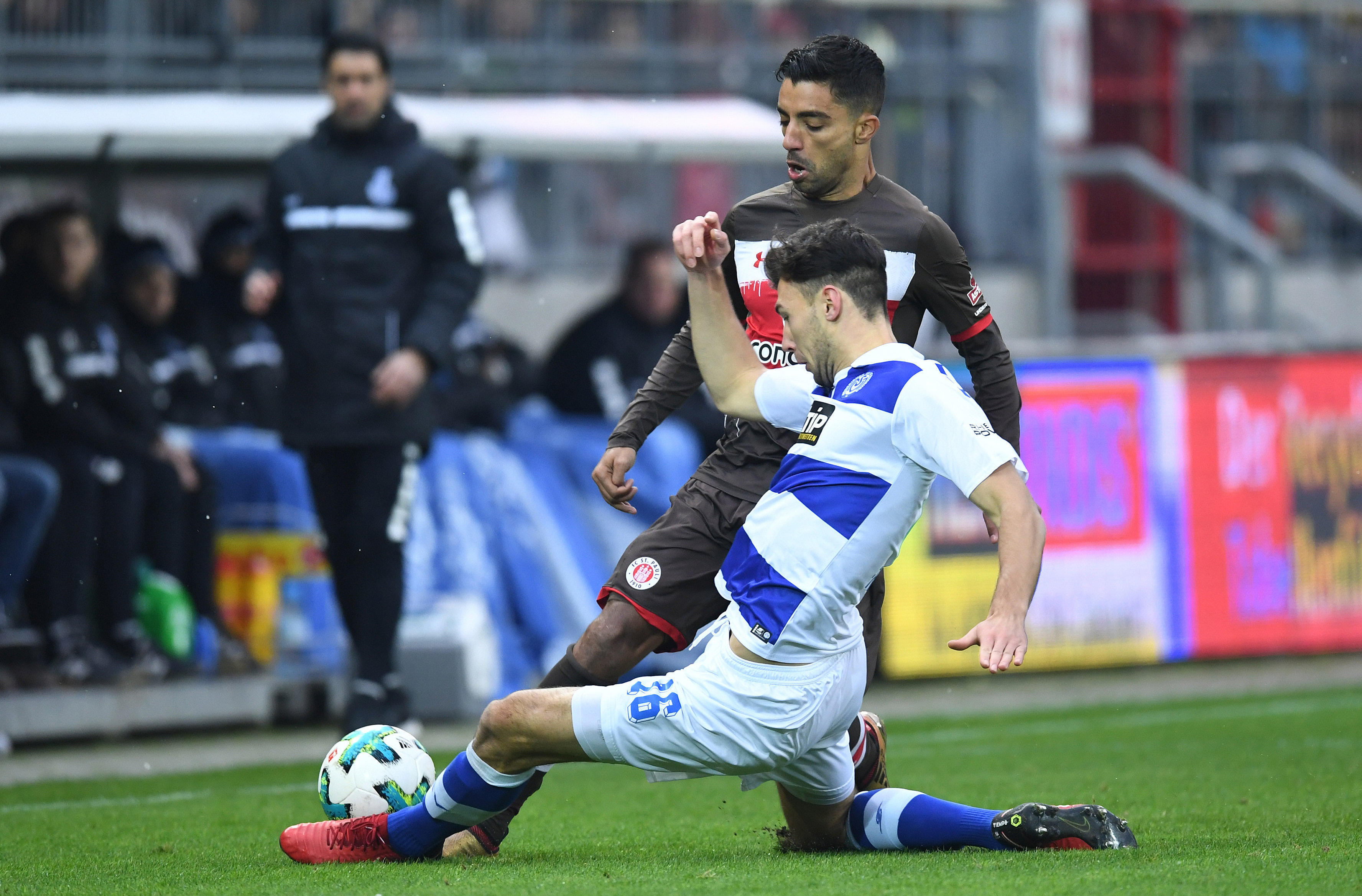 Lukas Fröde slides in to stop Sami Allagui.